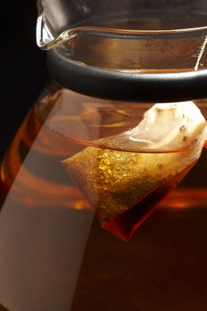 macro pic of glassy teapot with tea bag