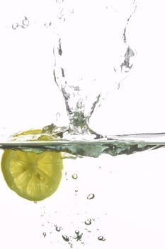 macro picture of fresh lemon splashing water 
