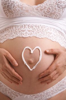 love symbol on the expectant mother stomach