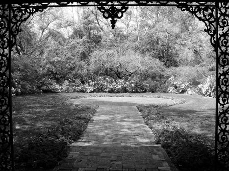 An iron fence borders a beautiful garden at Bellingrath Gardens and Home in Alabama.