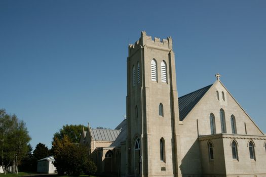 Stone church at Dannevirke, New Zealand, against blue sky.