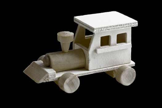 Wooden toy train with wheels on black background