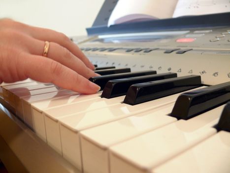Hand with piano keyboard