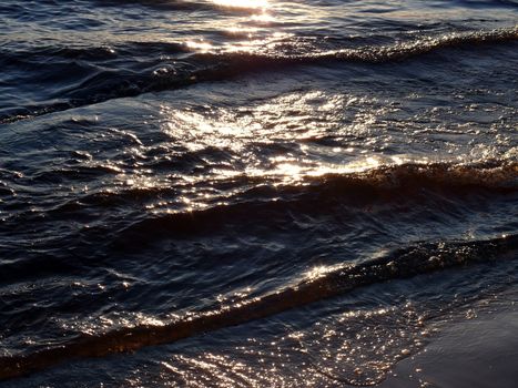 Waves in the water in sunset