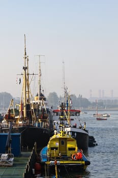 Different ships in harbor and on the river on a beautiful day