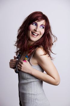 Studio fashion portrait of a young woman posing with a extreme makeup