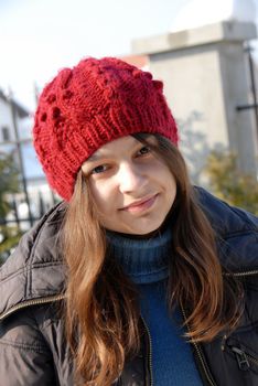 teenage smiling caucasian girl in red cup outdoor