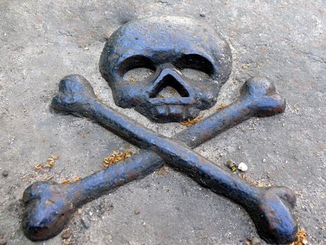 Bronze symbol of death in gravestone
