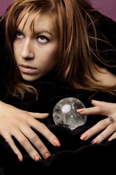 View of a beautiful woman on the bed with a transparent glass ball.