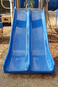 The blue slide on the children's playground 
