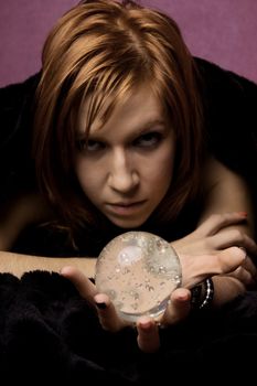 View of a beautiful woman on the bed with a transparent glass ball.