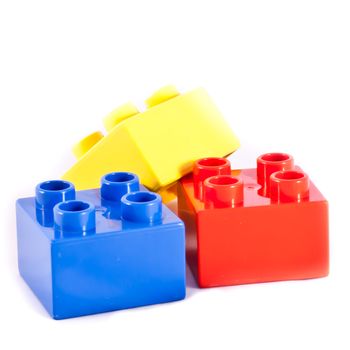 Plastic building blocks on white background. Bright colors.