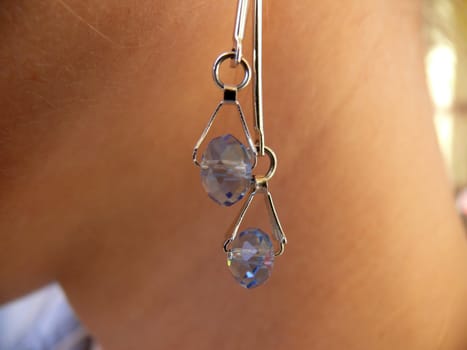 Gem earring in woman neck background