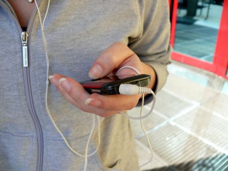 Girl with mobile phone and earphones