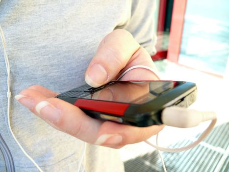 Girl with mobile phone and earphones