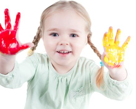 Studio shot of little girl playing with colors