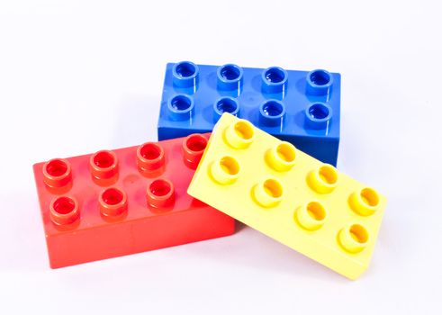 Plastic building blocks on white background. Bright colors.