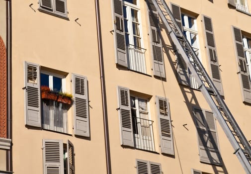 Ladder used to move furniture with elegant palace in background