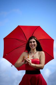 View of a beautiful woman with red dress and umbrella