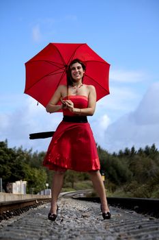 View of a beautiful woman with red dress and umbrella