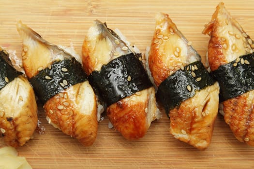 Group of broiled eel (unagi) sushi with sesame seeds
