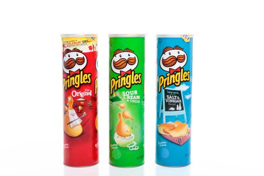 Varieties of Pringles brand potato Chips, Original, Sour Cream and Chives, and Salt and Vinegar.  Pringles are made by Proctor and Gamble. Pringles are made with 42% potato content, with the remainder being wheat starch and flours (potato, corn, and rice).   Editorial Only.  White background.