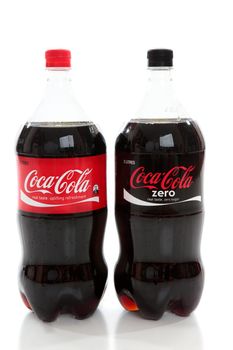 Bottles of Coca-Cola and Coke Zero, diet cola, caffeine flavoured carbonated drinks,soda drinks on a white background.