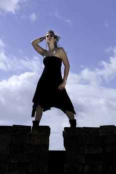 View of a beautiful woman with black dresson a fashion pose.