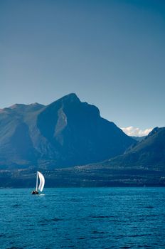 Sailboat at Lake Garda with mountains on the back