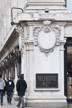 LONDON - FEBRUARY 04: Pedestrians walk past corner of Selfridges department store, on of the largest and most traditional department stores in England. February 04, 2011 in London, England.