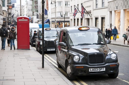 LONDON - FEBRUARY 04: Traditional black cabs parked in New Bond Street, one of the most expensive areas in London, home to fine art galleries and auction houses such as Sothebys. February 04, 2011 in London, England.