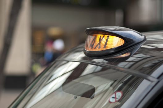Close up of a London black cab with yellow light on.