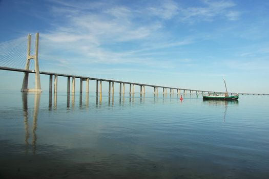 boat crossing the Tagus river neat Vasco da gama bridge