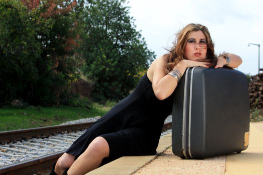 View of a beautiful woman with black dress upset with not catching the train