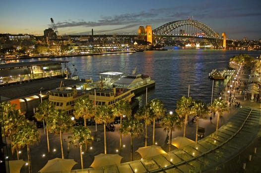 Circular Quay in Sydney, night photo, harbour bridge in background