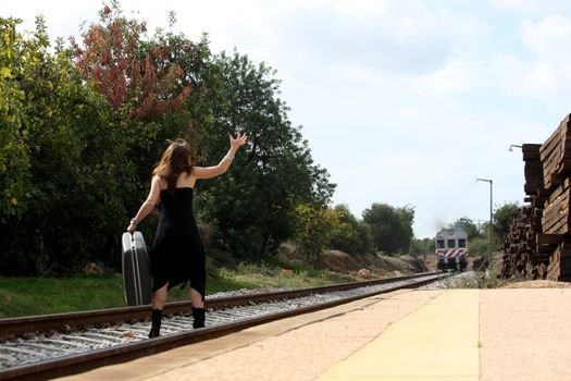 View of a beautiful woman with black dress upset with not catching the train