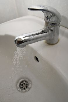 dirty water tap, running water, white basin