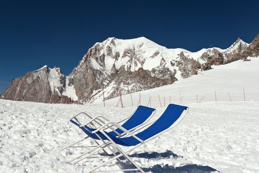 two chairs on the glacier with Mont Blanc mountain on background