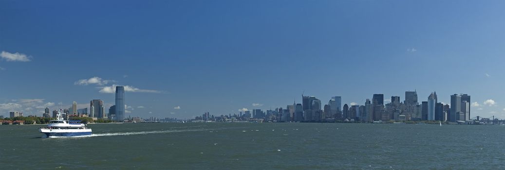 white boat going from nyc to statue of liberty, panorama photo