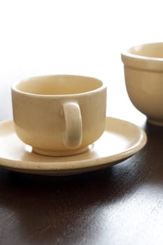 Empty brown ceramic coffee cup and bowl