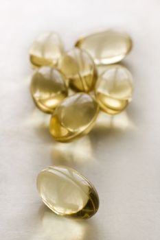 fish oil capsules on white background, shallow depth of view