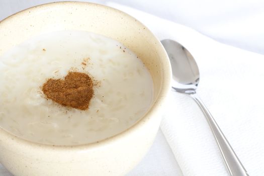 Bowl of rice pudding and cinnamon heart