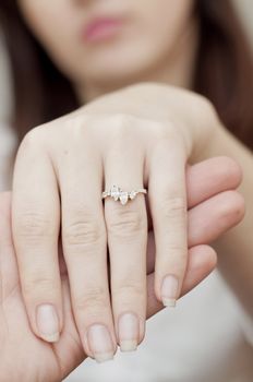 an image of engagement ring inserted into finger