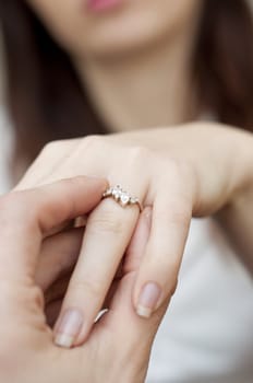 an image of situation of inserting engagement ring into a finger