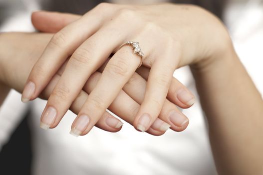 an image of engagement ring inserted into finger