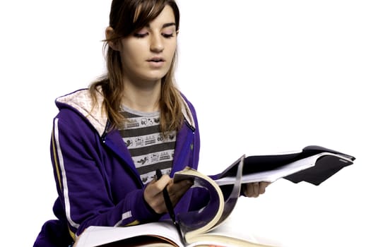 View of a teenager school girl studying on a white background.
