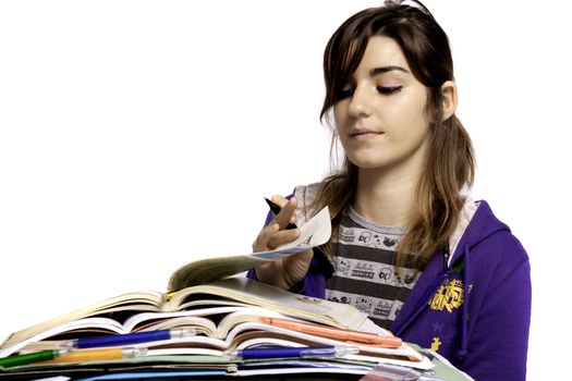 View of a teenager school girl studying on a white background.