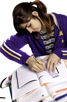 View of a teenager school girl studying on a white background.
