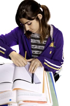 View of a teenager school girl studying on a white background.