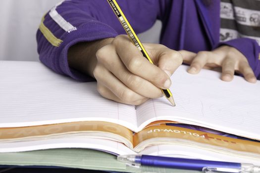 Close up view of a teenager school girl studying the books.